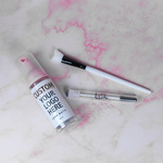 An image showing a custom 3-piece lash aftercare kit with logo, including 3 bottles with foam cleanser, lash wands, and cleansing brushes, displayed on a marble surface with pink veining.